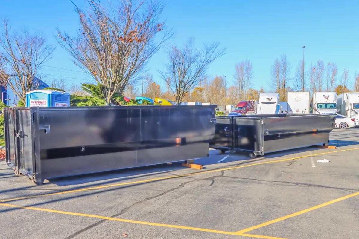 Professional dumpster rental service with roll-off container on residential driveway in Mayville